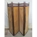 An Edwardian floor standing four fold screen, the mahogany frame enclosing material panels with