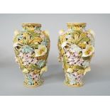 A pair of Hungarian Zsolnay Pecs vases of pierced double skin form with all over floral detail and