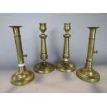 Pair of brass ejector candlesticks together with a further pair of brass gun barrel candlesticks (