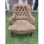 A late Victorian spoon back drawing room chair, with floral patterned upholstery and buttoned