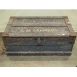 A vintage stained pine travelling chest with hinged lid, twin lock and side carrying handles,