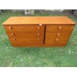 A Stag teak low long bedroom chest fitted with an arrangement of six drawers, approx 140 cm long x