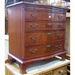 A reproduction Georgian style mahogany veneered serpentine chest of four long graduated drawers