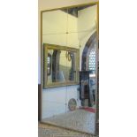 A substantial wall mirror, the simple moulded and gilt painted pine frame enclosing ten plates