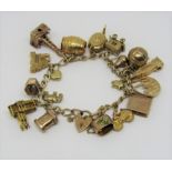 Good 9ct curb link charm bracelet with heart padlock clasp, hung with an interesting collection of