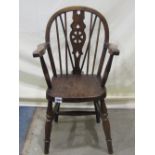 A child size Windsor stained elm and beechwood wheel open elbow chair