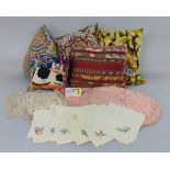 Box of mixed textiles including a Kelim cushion, three needlepoint cushions, four flags, vintage