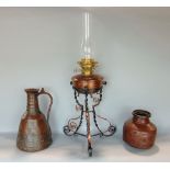 Benham & Froud planished copper oil lamp upon a barley twist wrought iron and copper tripod stand,