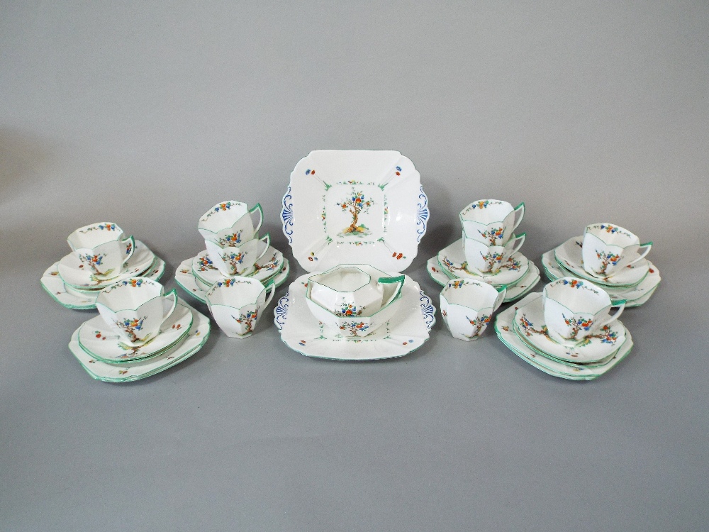 A collection of Shelley Art Deco tea wares, with fruiting tree decoration, comprising a pair of cake