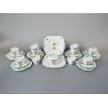 A collection of Shelley Art Deco tea wares, with fruiting tree decoration, comprising a pair of cake