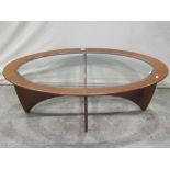 A G Plan Astro low occasional table of oval form with inset glass top, raised on a shaped