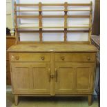 A vintage Ercol light elm and beechwood kitchen dresser, the base enclosed by a pair of twin