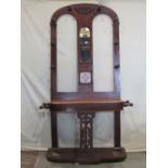 A Victorian mahogany hall stand of full height, the raised arched back with central further arched