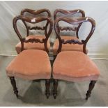 A set of four Victorian rosewood dining chairs, the kidney shaped backs with scrolled and carved