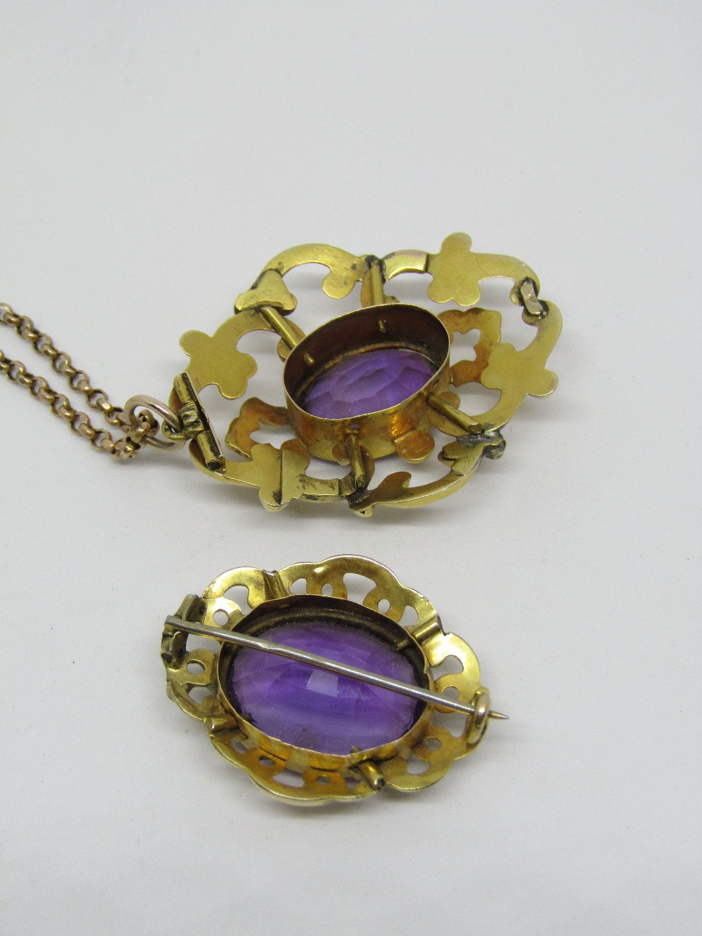 Victorian amethyst and yellow metal brooch with scrolled mount, together with a similar pendant hung - Image 2 of 2