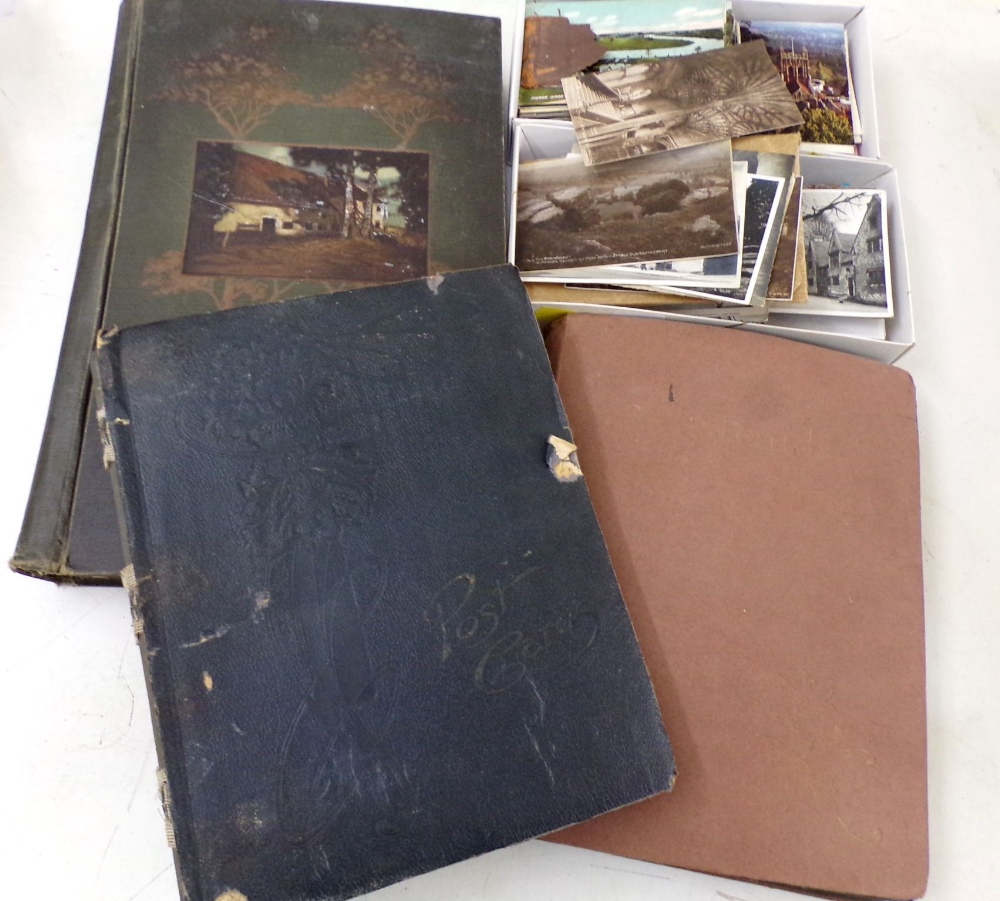Three albums containing a collection of early 20th century British and worldwide topographical