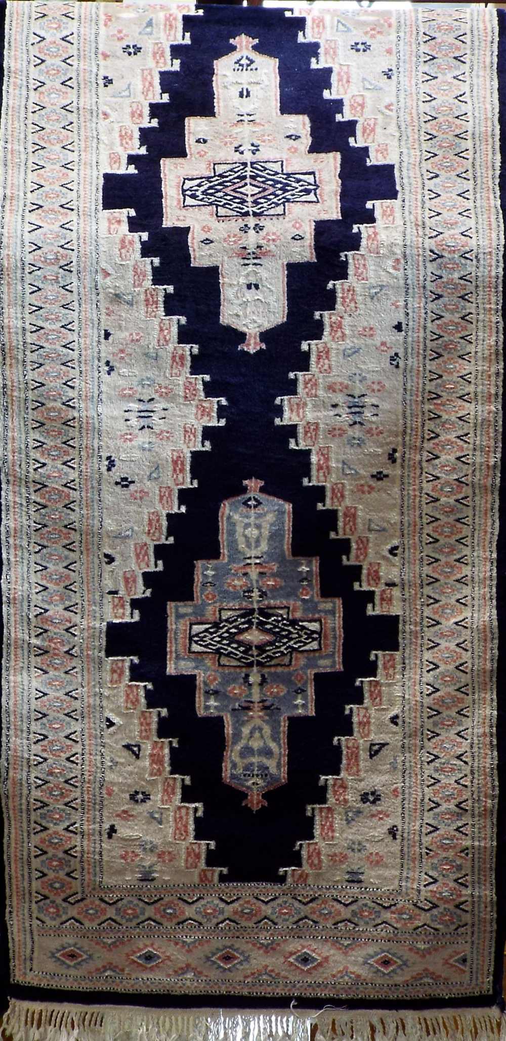 Keshan runner with central ivory medallions upon a navy blue ground 400 x 80 cm