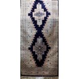 Keshan runner with central ivory medallions upon a navy blue ground 400 x 80 cm