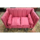 A small Georgian two seat sofa with raised sides and back, Regency style pink striped upholstery,