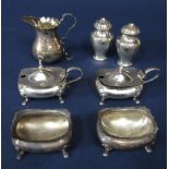 A collection of silver cruet items to include a pair of lidded mustards with blue glass liners, pair