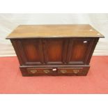 A small 18th century style oak coffer bach with rising lid, over a panelled framework with two small