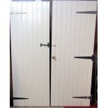 Two painted pine tongue and groove constructed doors with thumb latches and strap work hinges, 195
