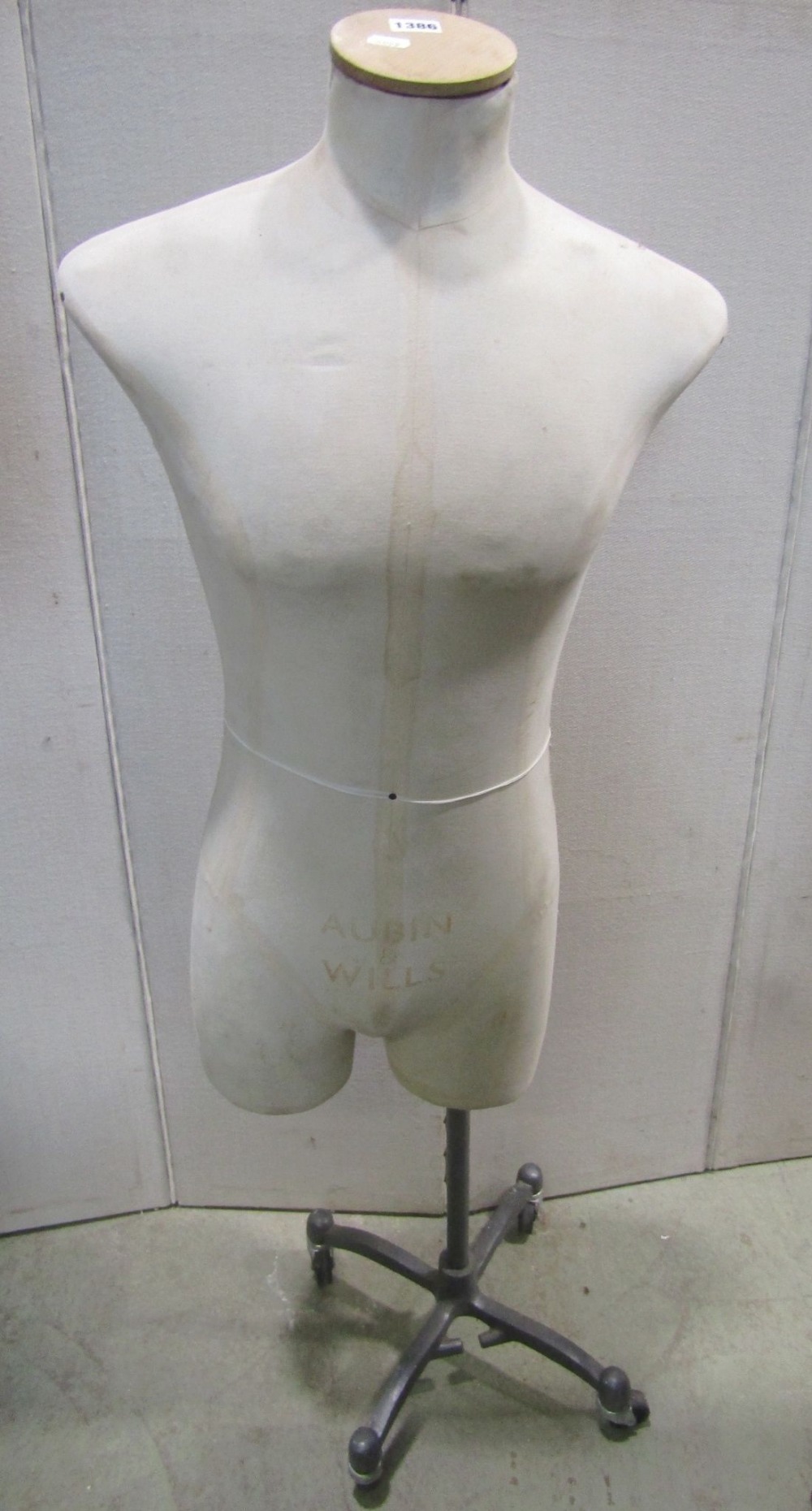 A vintage tailors/shop display mannequin labelled Aubin & Wills raised on a cast alloy stand with