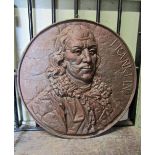 A cast iron circular walk plaque with raised head and shoulder relief of Benjamin Franklin, 54cm