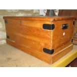 A Victorian stripped pine blanket box with hinged lid and side carrying handles