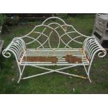 A cream painted and weathered contemporary light steel two seat garden bench, with scrolled arms,