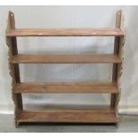 A stripped pine framed open flight of wall shelves, with shaped outline, 85cm wide x 18cm deep x