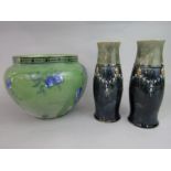 A pair of Royal Doulton vases of curved cylindrical form with relief moulded mask and swag