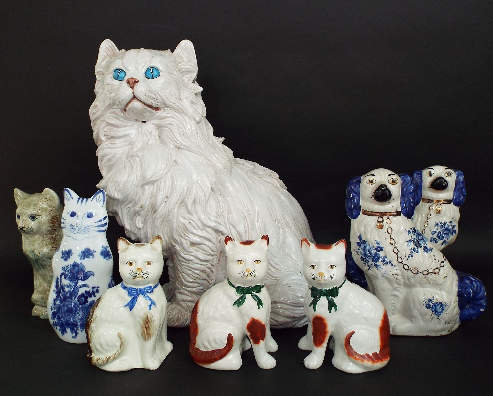 A substantial hollow moulded pottery model of a long haired white cat in seated pose, 56 cm approx