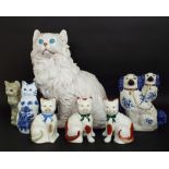 A substantial hollow moulded pottery model of a long haired white cat in seated pose, 56 cm approx