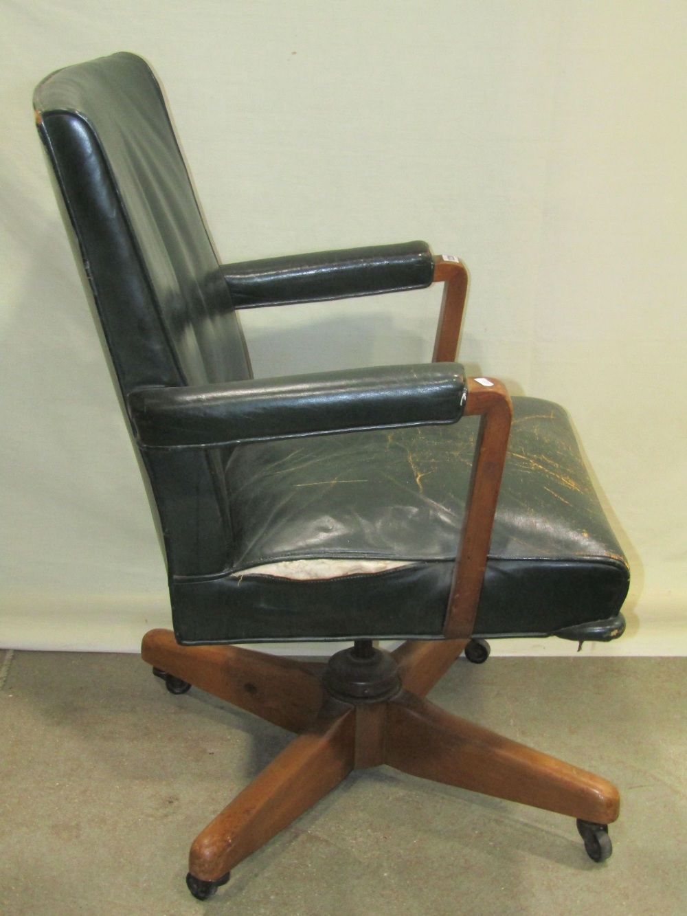 A vintage swivel office desk chair, with green leather upholstered seat, back and arms, raised on - Image 2 of 2