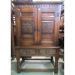 A reproduction Old English style oak side cupboard, freestanding and enclosed by a pair of