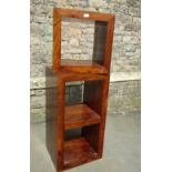 A contemporary hardwood floor standing open modular shelving unit with central fixed shelf, together