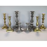 A collection of four pairs of candlesticks to include four brass and four pewter (8)