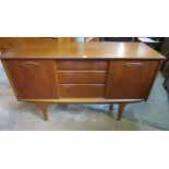 A retro teak sideboard fitted with a tower of three central long graduated drawers flanked by