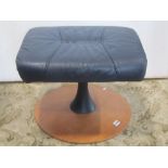 A soft stitched leather upholstered footstool with circular teak veneered platform base label
