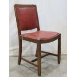 A set of six stained beechwood framed dining chairs with drop in seats and padded backs and