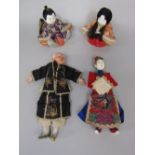 A pair of antique Chinese male and female opera dolls, together with a pair of seated oriental