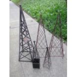A pair of contemporary weathered light steel and wire work pyramid shaped garden obelisks, 135cm