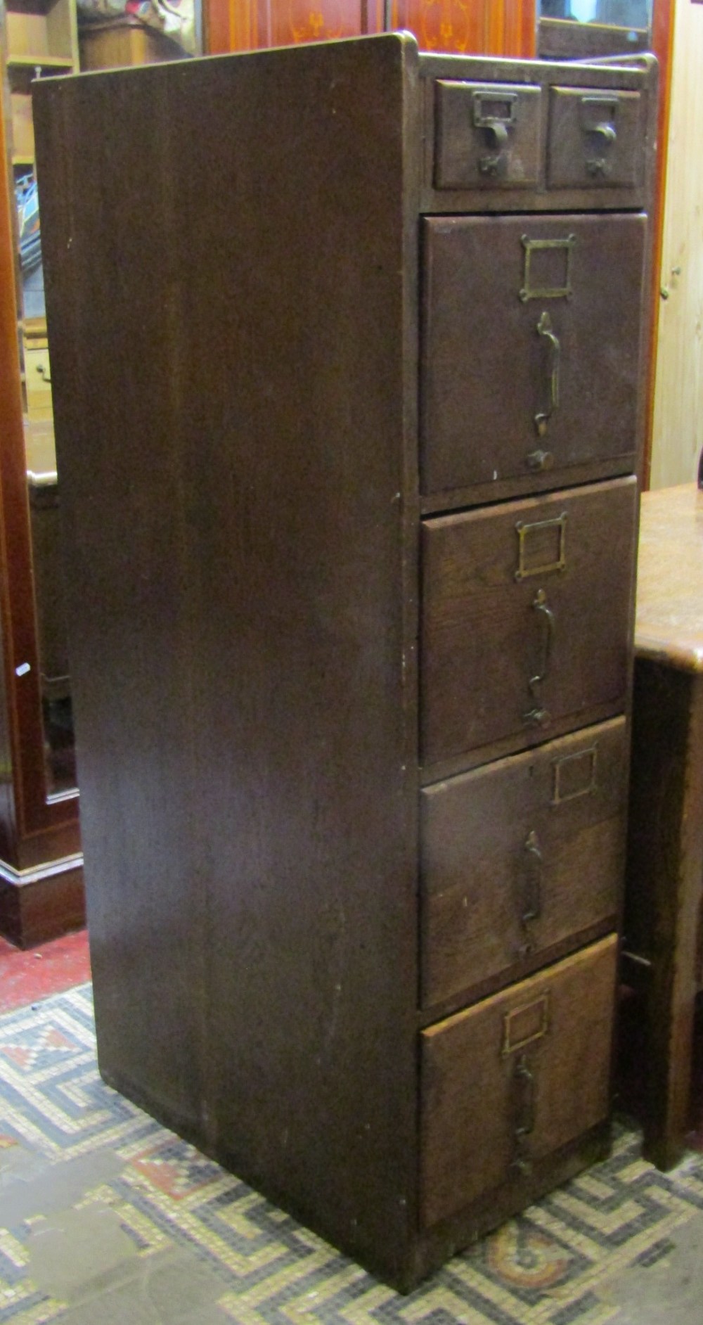 An Edwardian oak floor standing office filing cabinet, fitted with an unusual arrangement of two