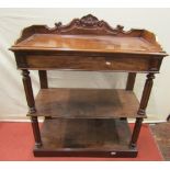 A small 19th century mahogany three tier serving table with raised and shaped scrolled back over a