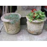 A pair of weathered contemporary composition stone planters of squat cylindrical form with raised