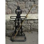 A Victorian cast iron umbrella/stickstand, the decorative raised pierced back, with trailing