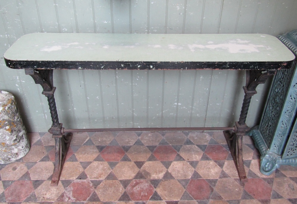A Victorian Gothic revival cast iron table with possibly associated rectangular narrow timber top,