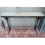 A Victorian Gothic revival cast iron table with possibly associated rectangular narrow timber top,