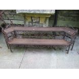 A low two tier plant stand of stepped form, the iron frame with decorative scroll work detail and